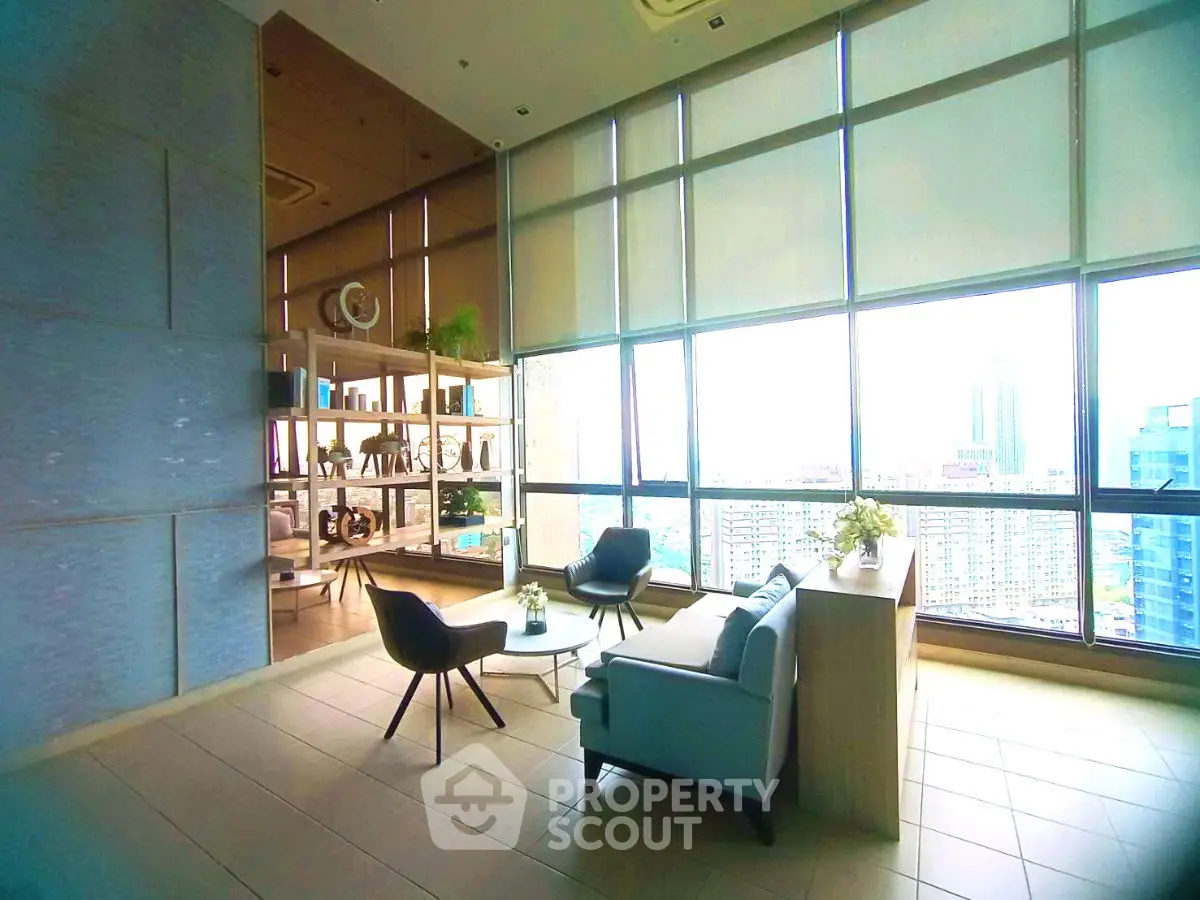 Luxurious high-rise living room with panoramic city views and modern decor.