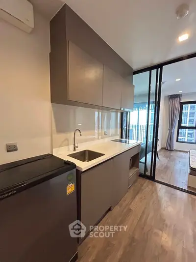 Modern kitchen with sleek cabinetry and compact design in urban apartment