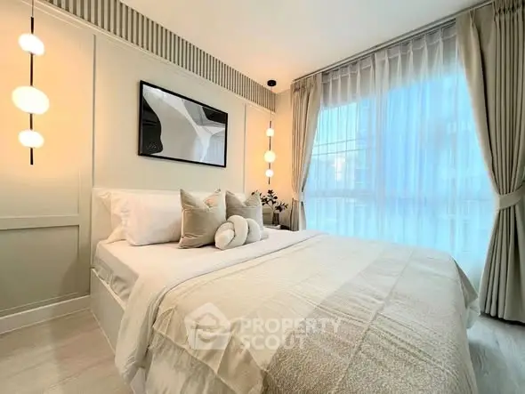 Luxurious bedroom with elegant decor and large window for natural light.