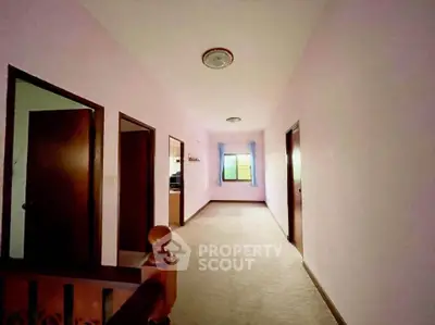 Spacious hallway with soft lighting and multiple doorways, perfect for a cozy home atmosphere.