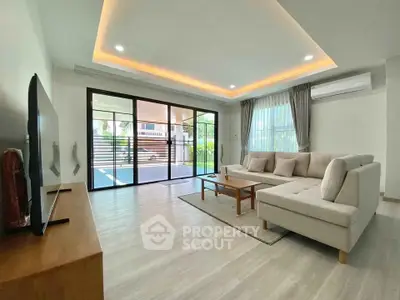 Spacious modern living room with large windows and elegant furniture