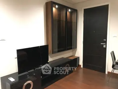 Modern living room with sleek TV stand and stylish wooden flooring.
