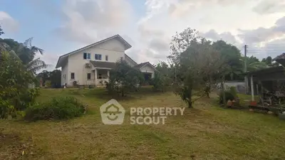 Charming countryside house with spacious garden and lush greenery, perfect for serene living.