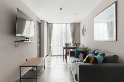 Modern living room with sleek furniture and large TV, perfect for relaxation and entertainment.