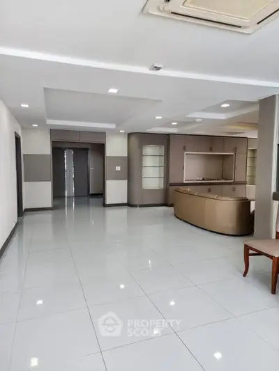 Spacious modern living room with sleek design and ample natural light.
