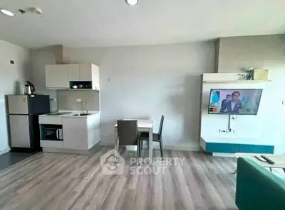 Modern open-layout kitchen and dining area with sleek appliances and stylish decor.