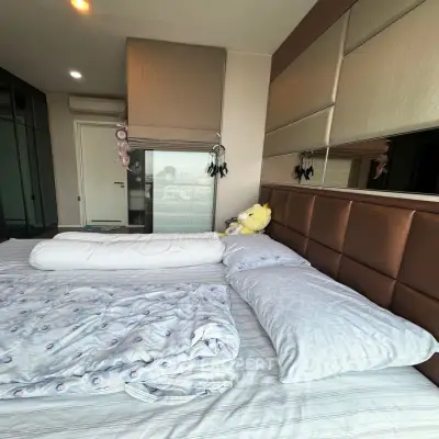 Cozy bedroom with plush headboard and modern decor, perfect for relaxation.