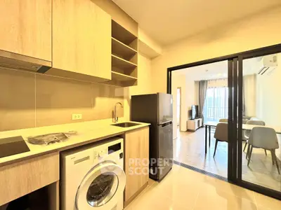 Modern kitchen with washing machine and open layout to living area