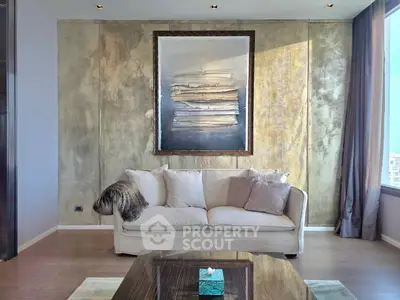 Luxurious living room with elegant decor and large artwork, featuring a plush sofa and modern design elements.