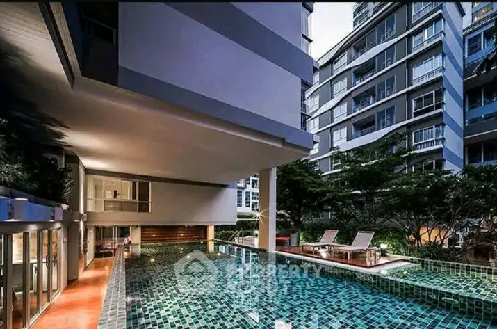 Luxurious condominium with modern pool and stylish architecture, perfect for urban living.