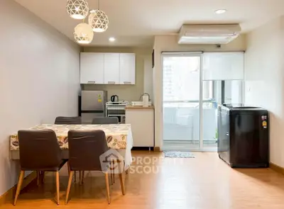 Modern open-layout kitchen and dining area with balcony access