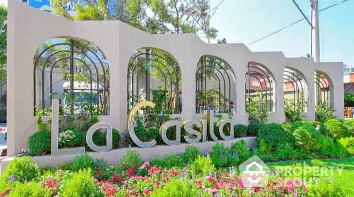 Elegant entrance of La Casita with lush garden and modern architectural design.