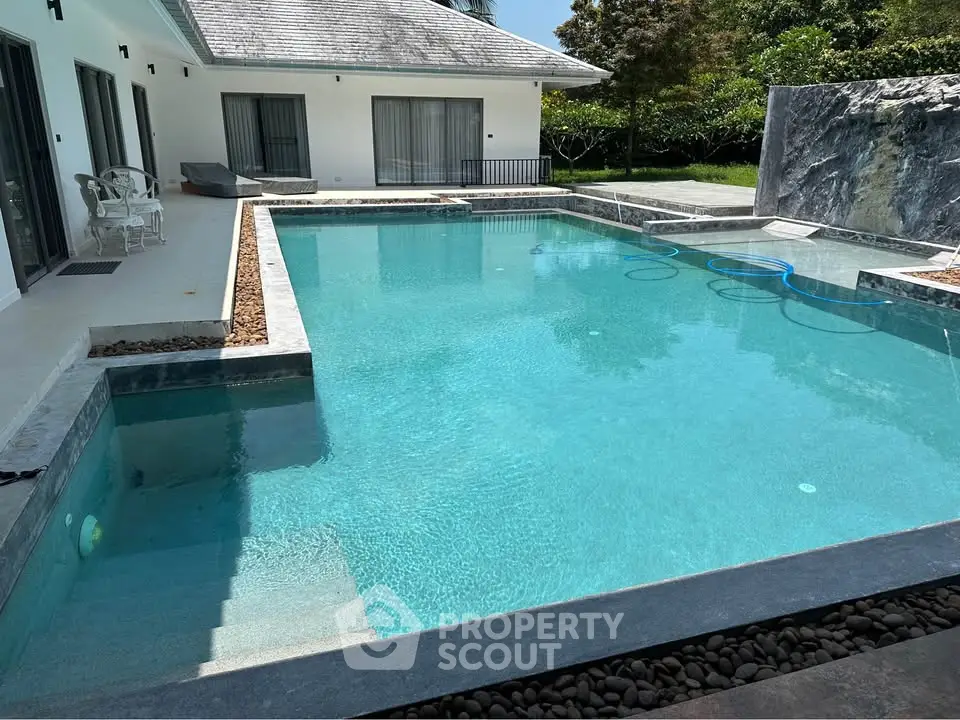 Luxurious modern villa with stunning private pool and lush greenery, perfect for relaxation and entertainment.