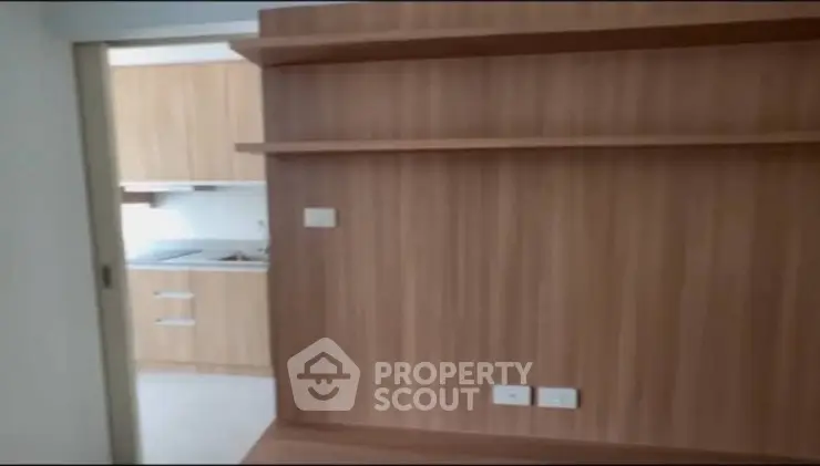 Modern kitchen with wooden cabinetry and sleek design in a contemporary apartment.