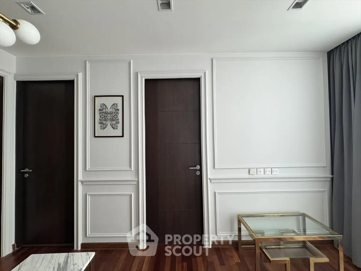 Elegant interior with dark wood doors and modern decor in a stylish living space.