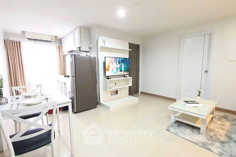 Modern living room with dining area and sleek kitchen appliances