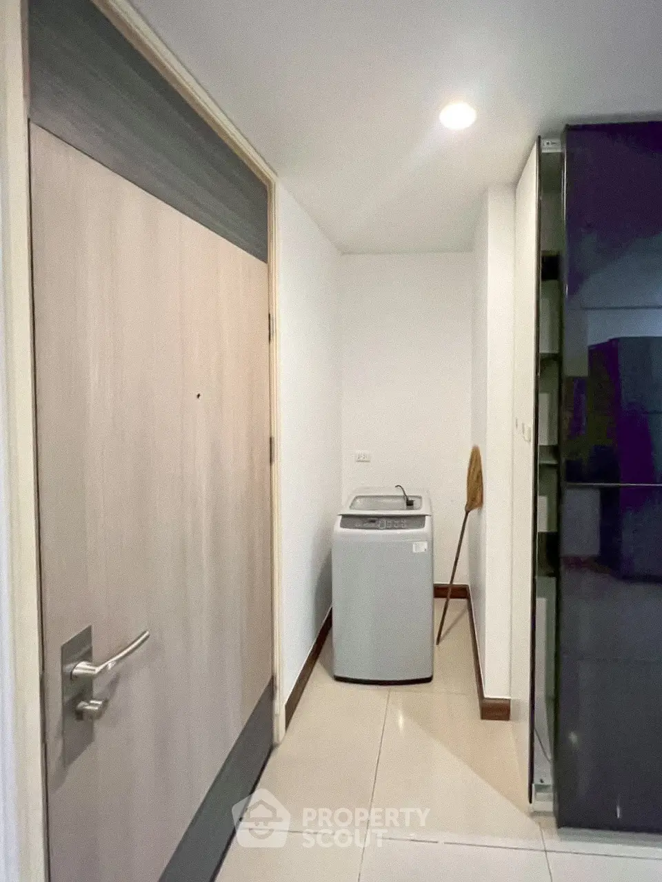 Modern laundry area with washing machine in sleek apartment hallway