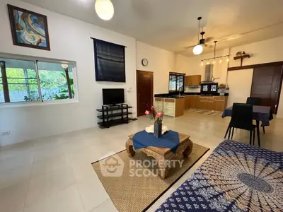 Spacious open-plan living room with modern kitchen and stylish decor