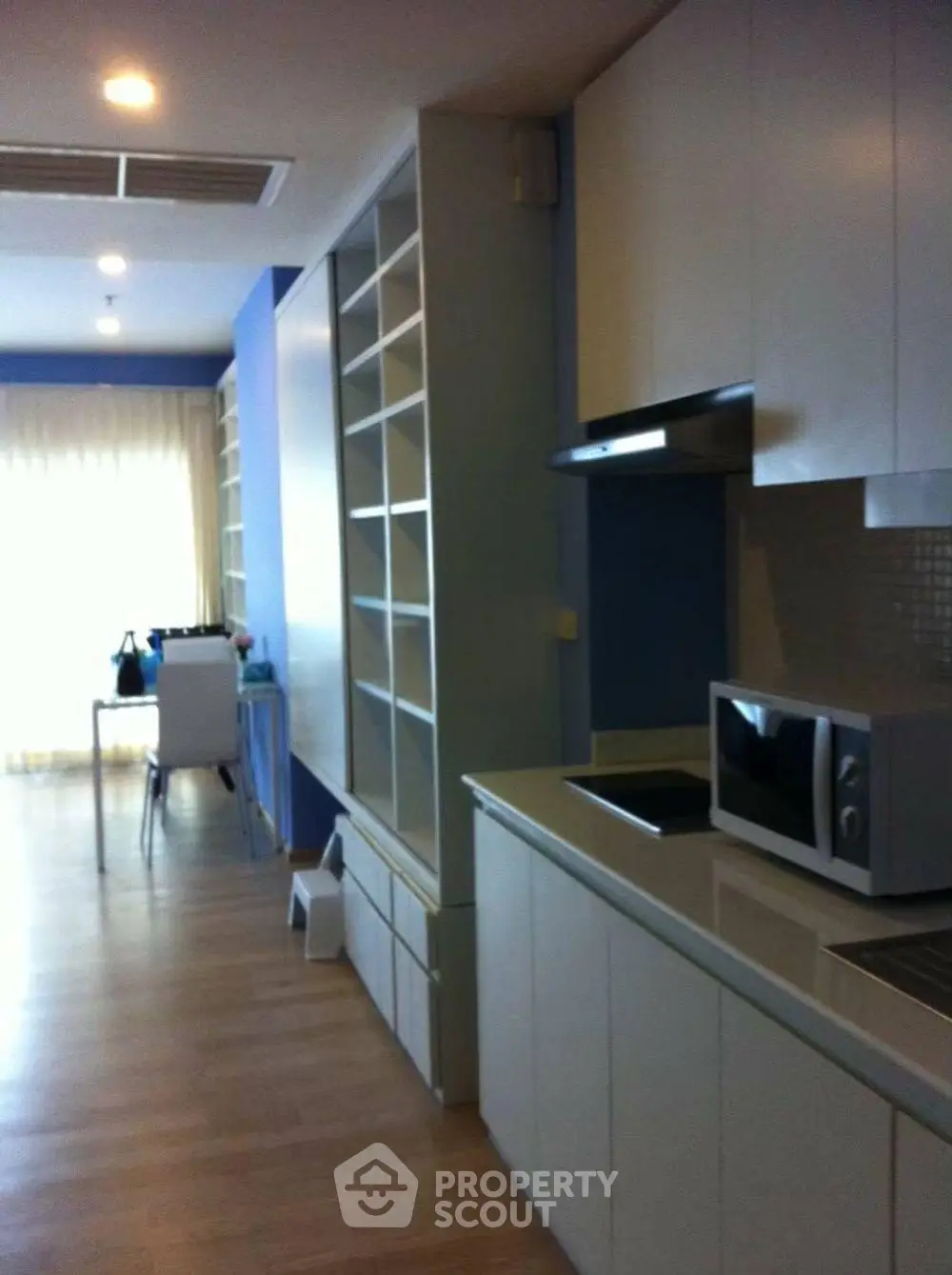 Modern kitchen with sleek cabinetry and built-in appliances in a stylish apartment.