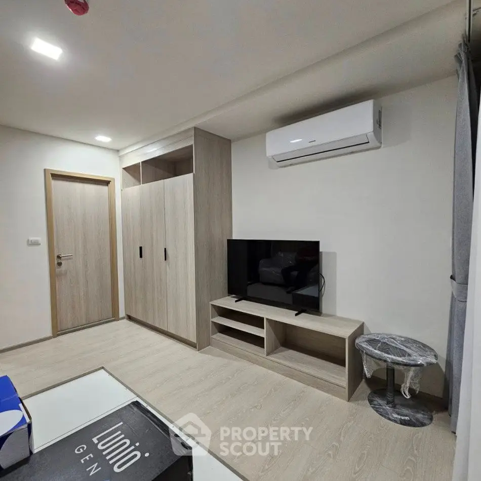Modern living room with sleek furniture and air conditioning unit