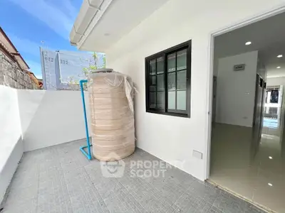 Spacious outdoor area with water tank in modern residential property