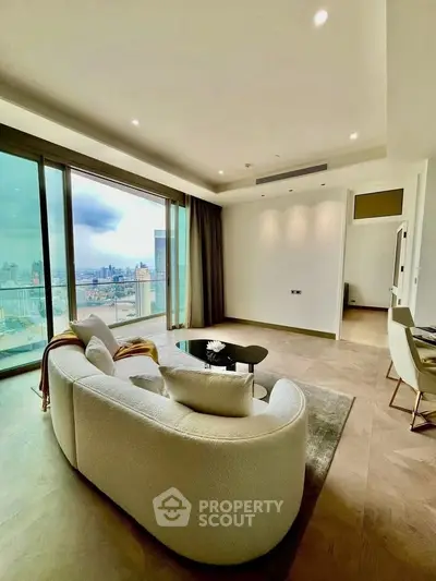 Luxurious living room with panoramic city view and modern furnishings in high-rise apartment.