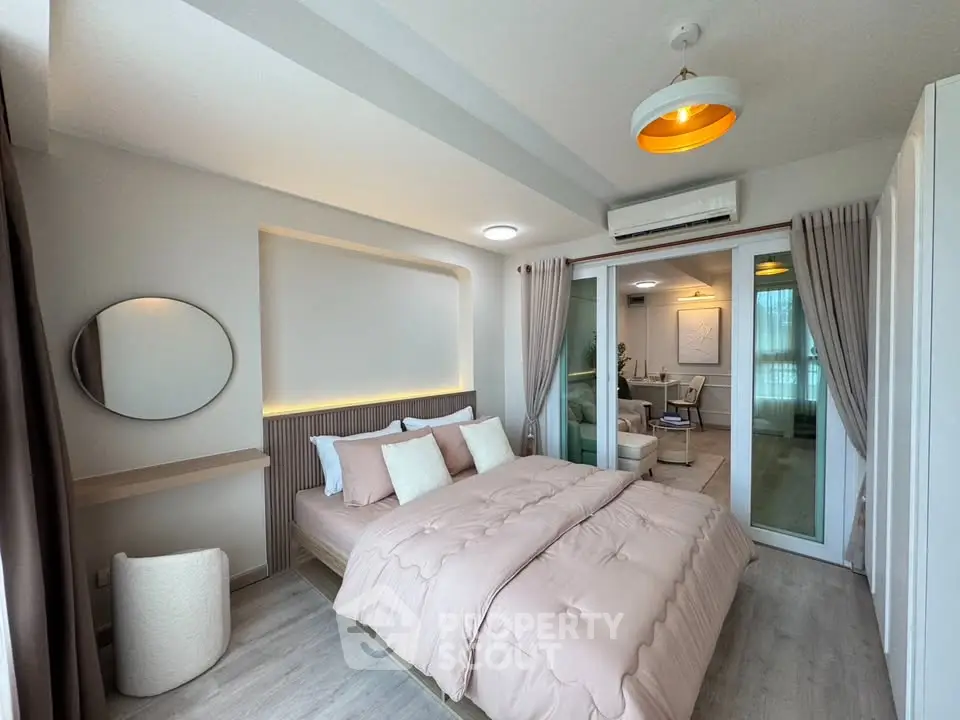 Modern bedroom with stylish decor and soft lighting, featuring a cozy bed and elegant furnishings.