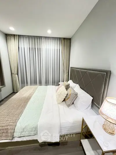 Luxurious bedroom with elegant decor and plush bedding in modern apartment