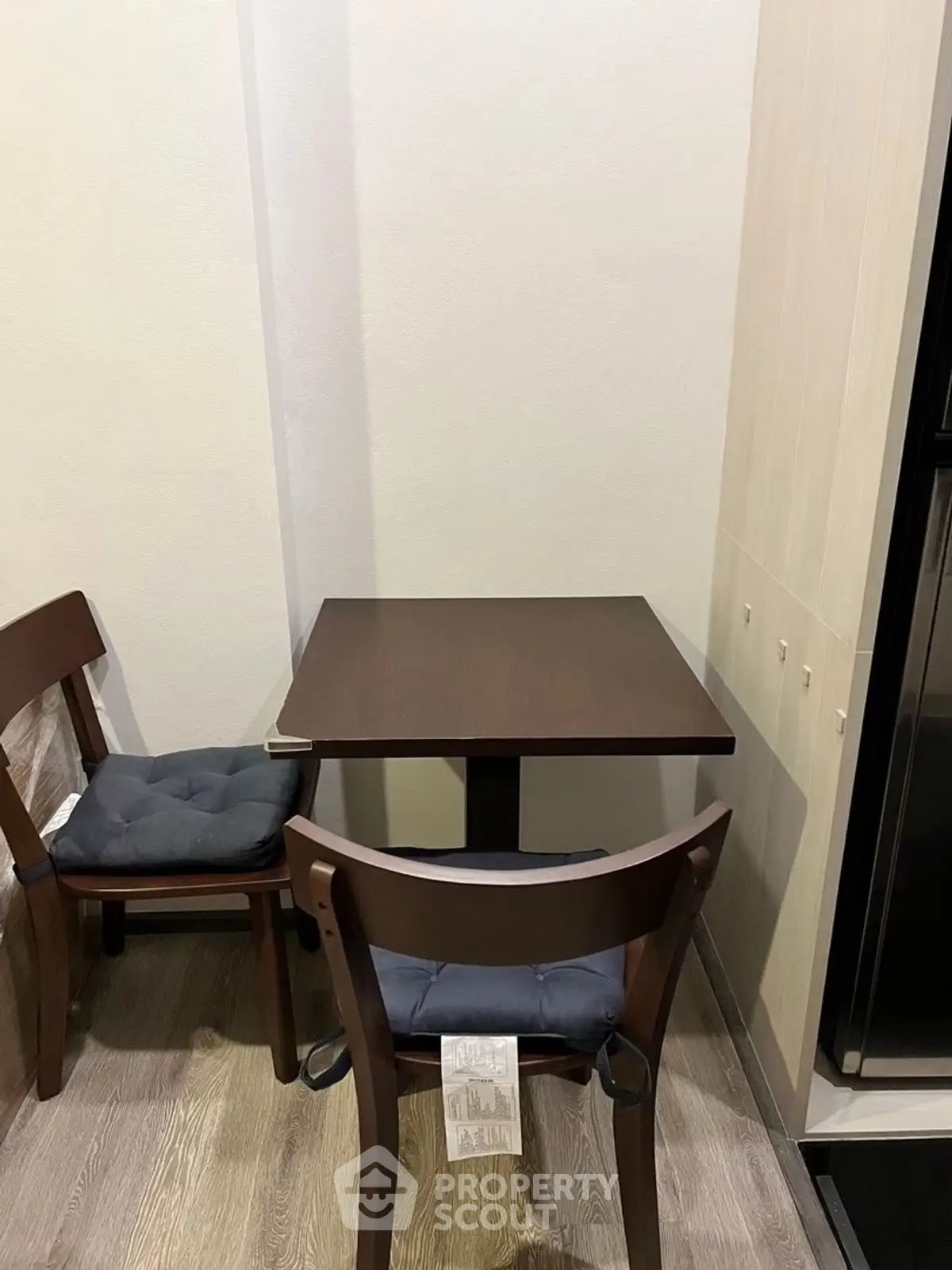 Cozy dining nook with wooden table and chairs in modern apartment