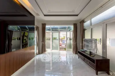 Spacious living room with large windows and modern decor