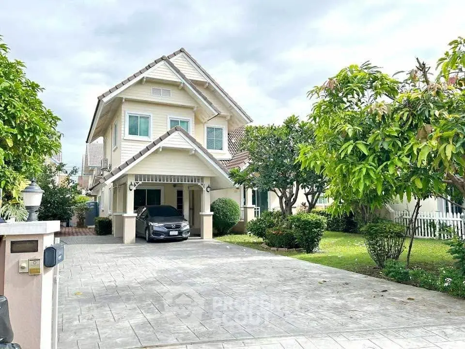 Charming two-story house with lush garden and spacious driveway