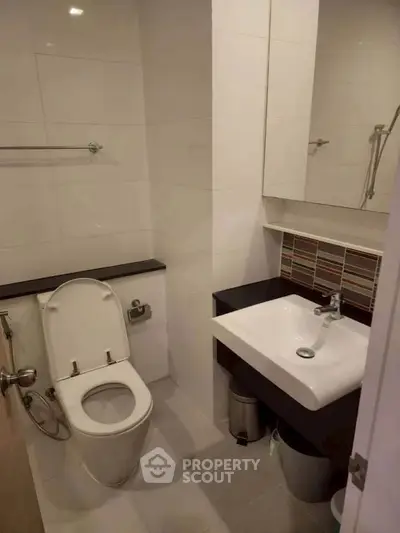 Modern bathroom with sleek fixtures and stylish tile accents, perfect for a contemporary home.