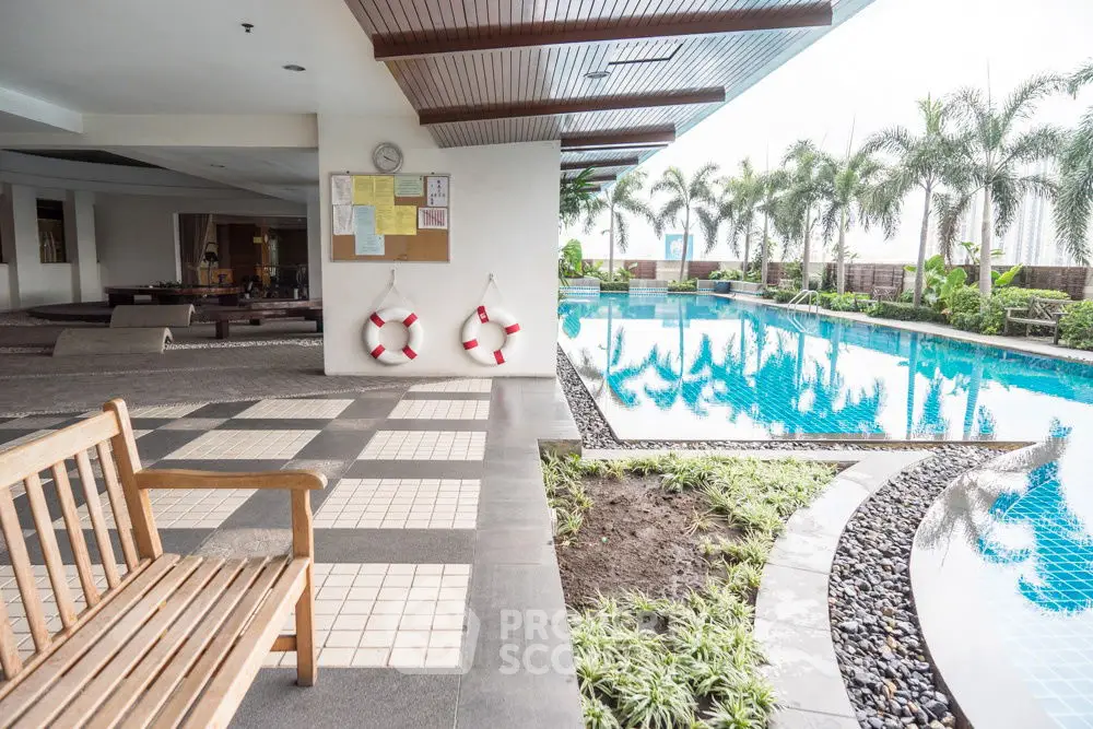 Luxurious poolside area with modern design and lush greenery, perfect for relaxation and leisure.