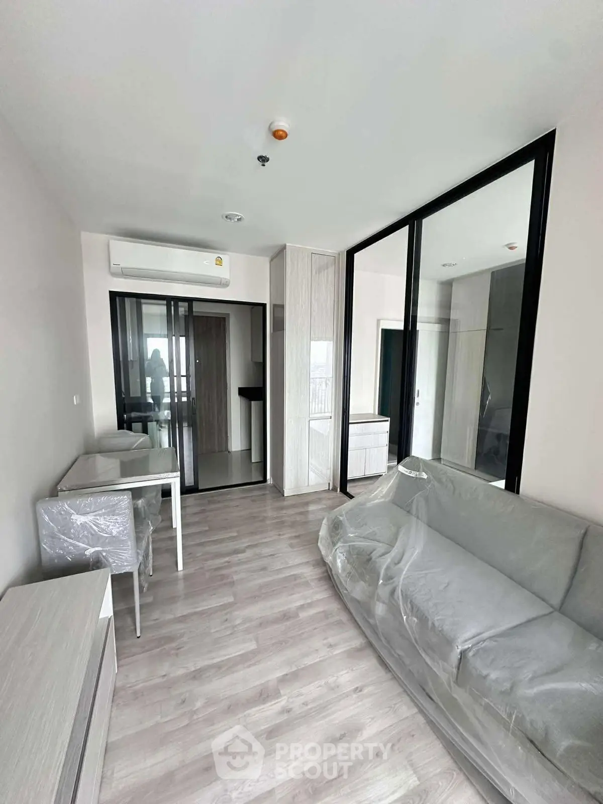 Modern living room with sleek design and large windows in a contemporary apartment.