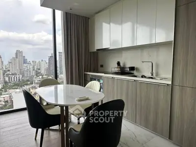 Modern kitchen with city view, sleek cabinetry, and elegant dining area in high-rise apartment.