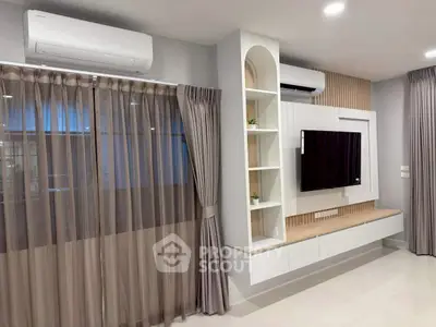Modern living room with sleek TV unit and air conditioning