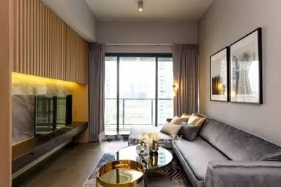 Modern living room with stylish decor and large window offering city view