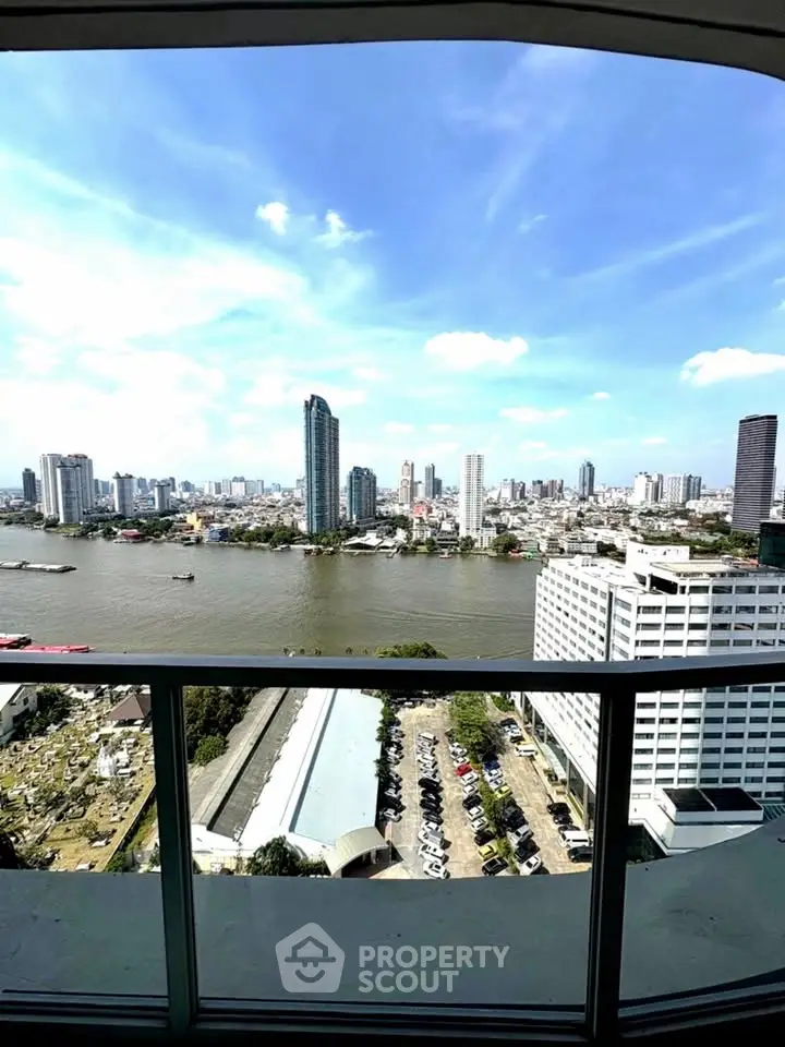 Stunning cityscape view from high-rise balcony overlooking river and skyline.
