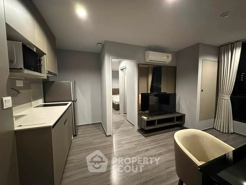 Modern open-plan living room with sleek kitchen and stylish decor