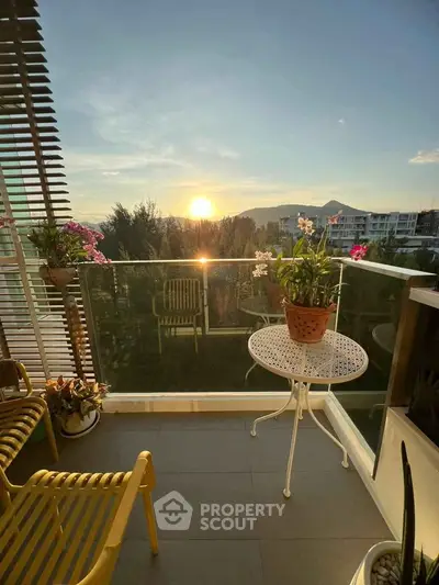 Charming balcony with stunning sunset view, perfect for relaxation and enjoying nature.