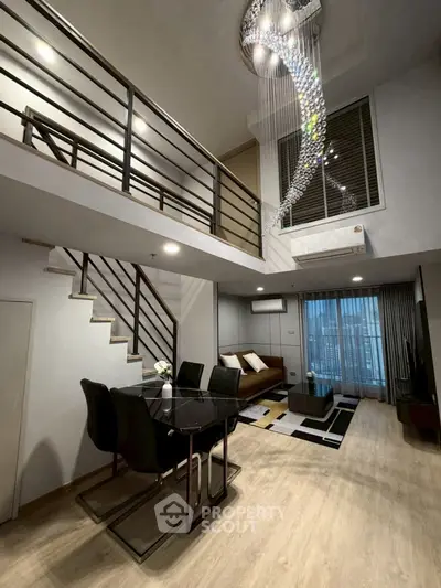 Luxurious modern living room with high ceiling and elegant chandelier in a stylish duplex apartment.