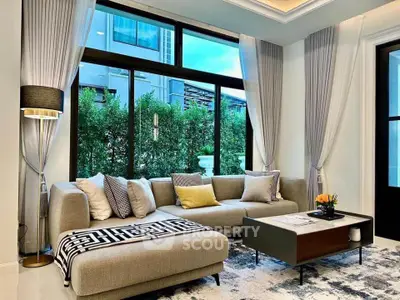 Luxurious modern living room with large windows and elegant decor