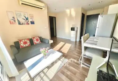 Bright and modern living room with stylish decor and open layout, featuring a cozy sofa and dining area.