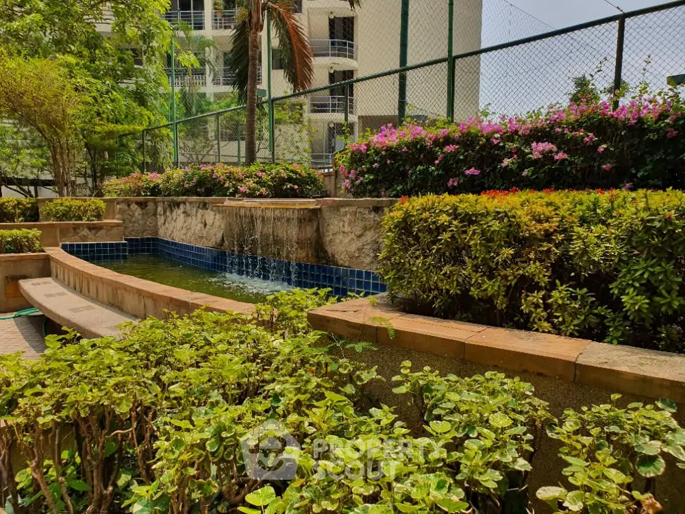 Lush garden area with water feature in modern residential complex