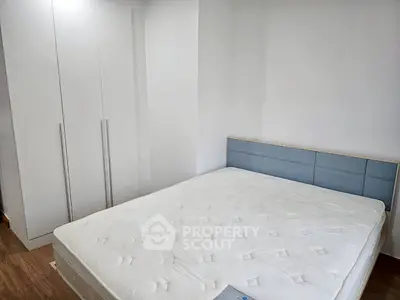 Modern minimalist bedroom with white wardrobe and comfortable bed