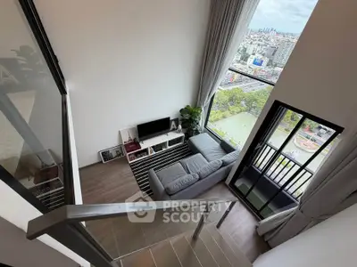 Stunning loft apartment with floor-to-ceiling windows and panoramic city views.