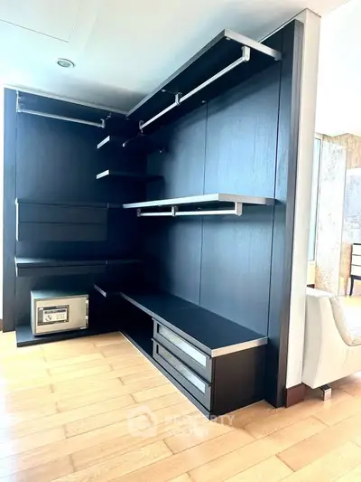 Spacious walk-in closet with modern shelving and secure safe in luxury apartment.