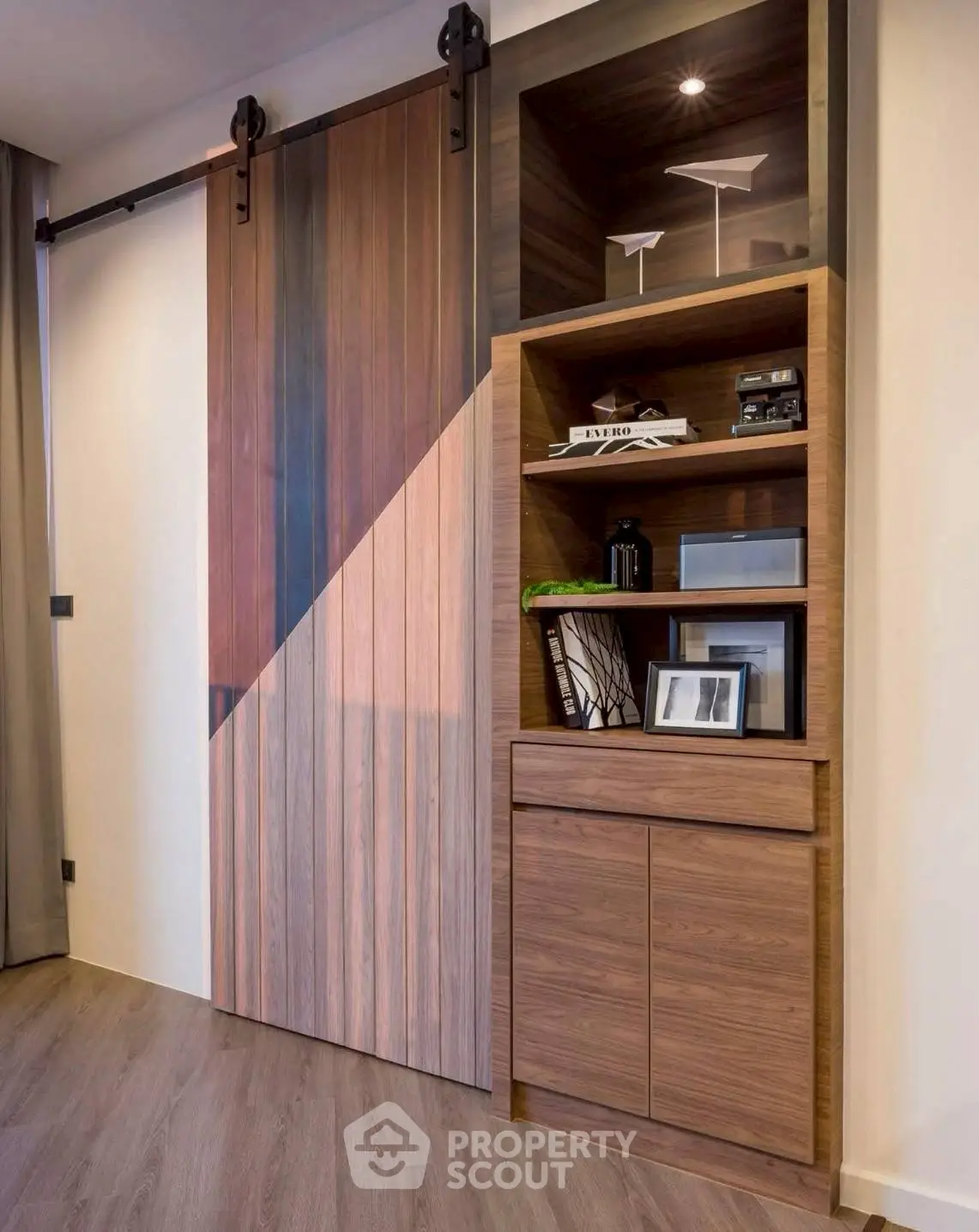 Modern interior with stylish wooden sliding door and built-in shelving unit.