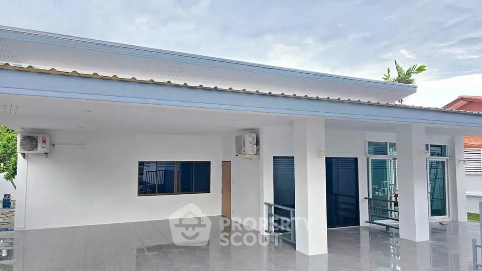 Modern single-story house with sleek design and spacious outdoor area, perfect for family living.