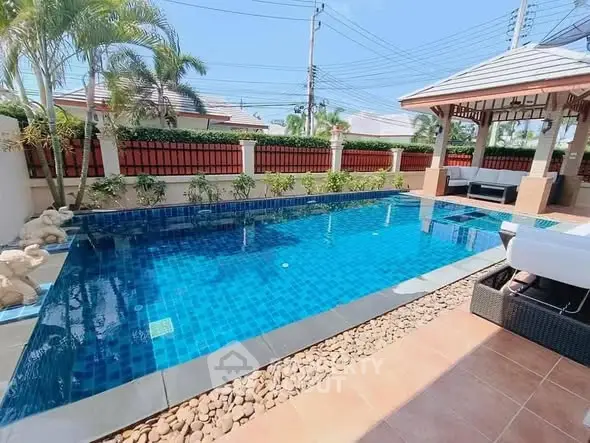 Luxurious private pool with elegant gazebo and lush landscaping in a serene residential setting.
